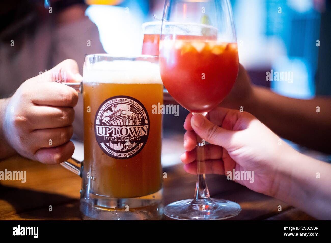 close up shot of craft beer in a huge mug with people cheers hitting the mug with mocktails cocktails in celebration socialization while they relax Stock Photo