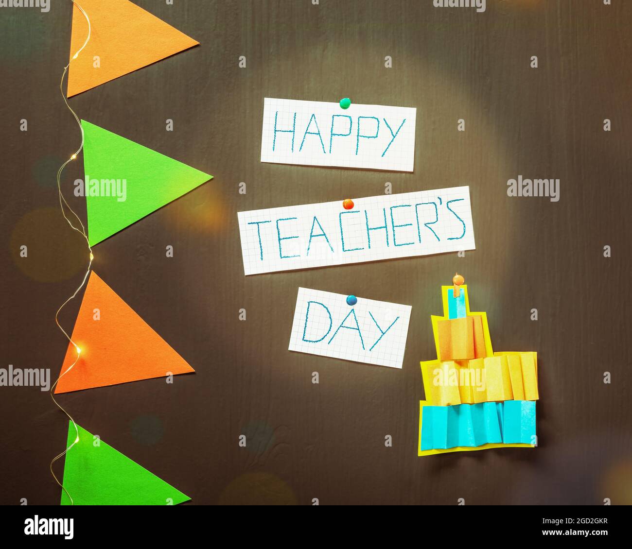 Teachers day concept. Holiday, school composition with paper creative cake, hand made inscription happy teachers day, red and green paper flags and a Stock Photo
