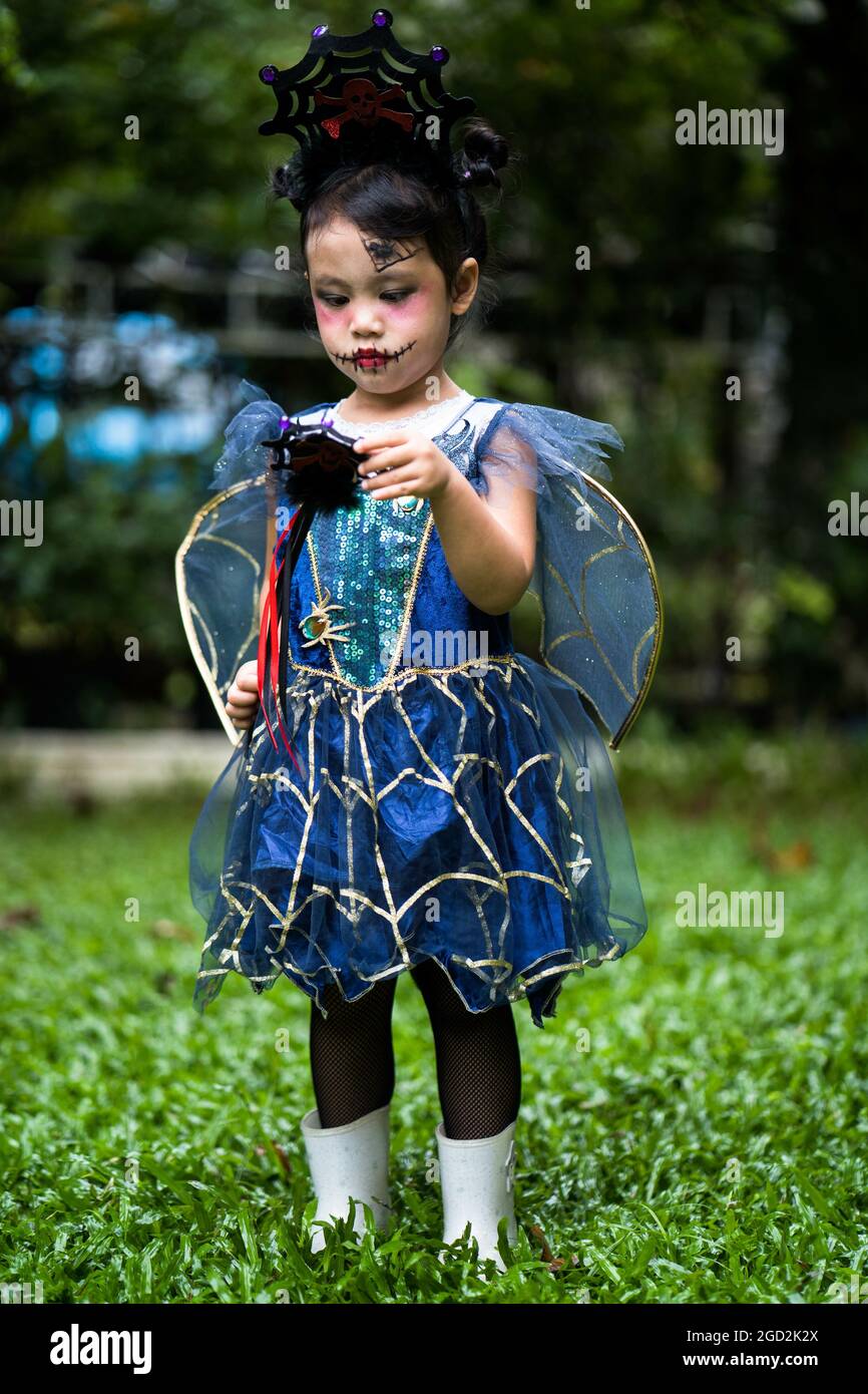 Vertical shot of a small Asian female child in a spider witch costume Stock  Photo - Alamy