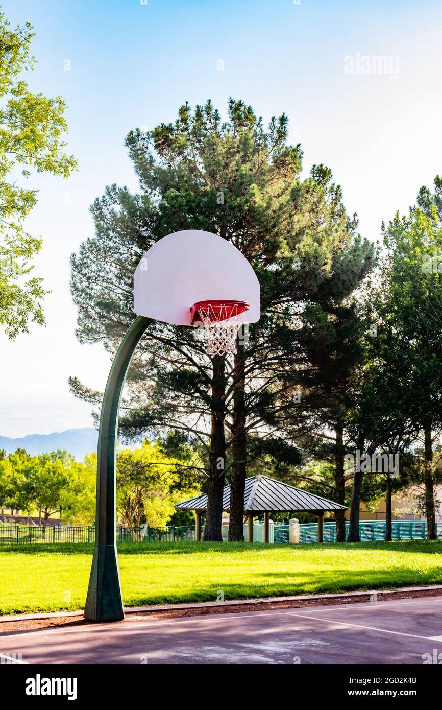 Basketball hoop and backboard in a park with no one on a sunny day Stock  Photo - Alamy