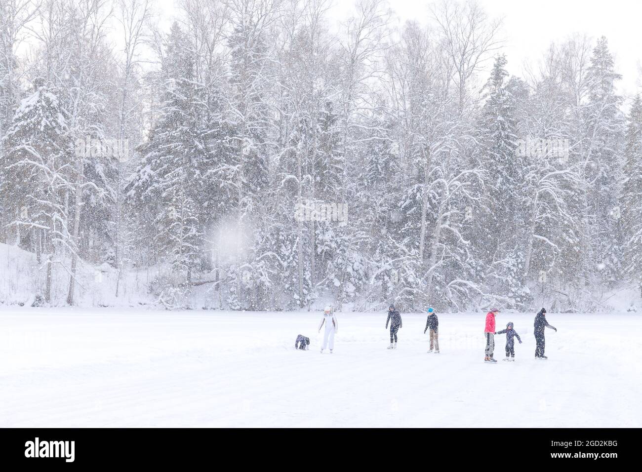People skating on frozen lake Stock Photo - Alamy