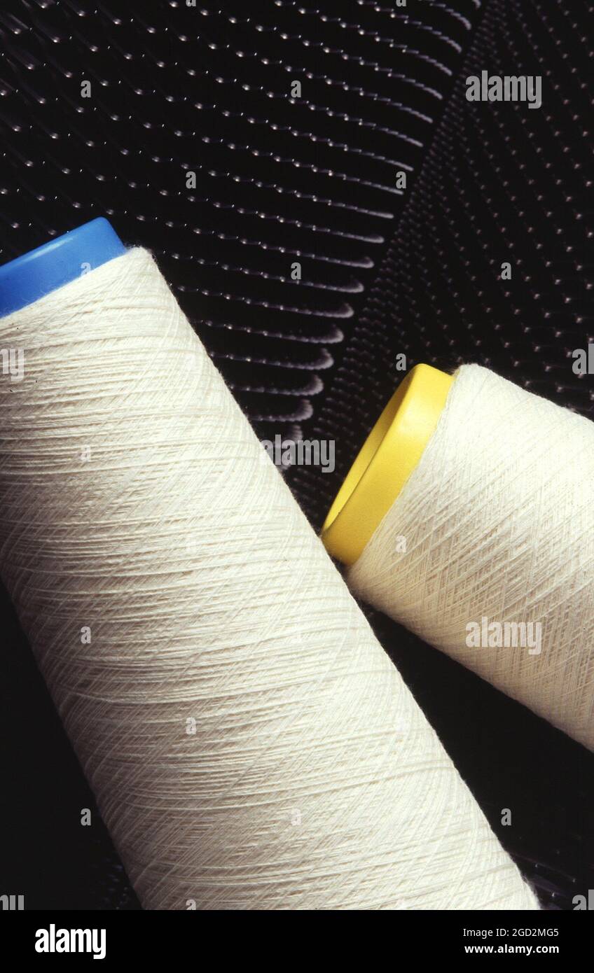 Conical cotton yarn coils made by spinning and winding. Conical coils are often used for
