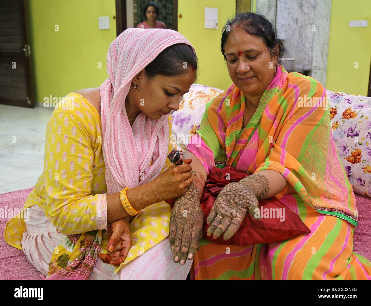 Beawar, India. 10th Aug, 2021. Indian woman get heena applied on her hands on the occasion of Sinjara festival ahead of Sawan Teej in Beawar. (Photo by Sumit Saraswat/Pacific Press) Credit: Pacific Press Media Production Corp./Alamy Live News Stock Photo