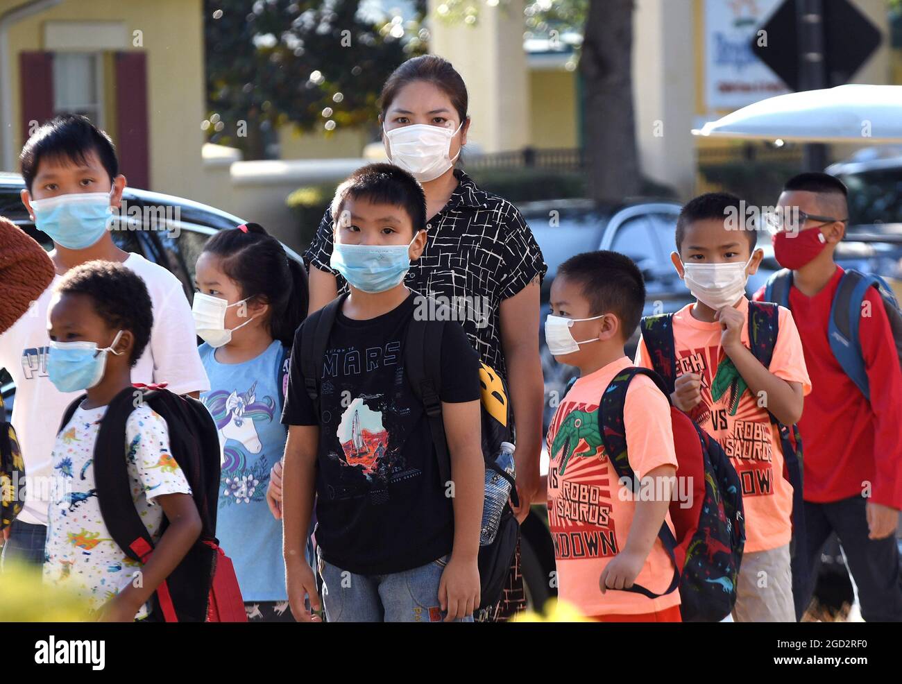 Orlando, United States. 10th Aug, 2021. Students wearing face masks arrive on the first day of classes for the 2021-22 school year at Baldwin Park Elementary School. Due to the current surge in COVID-19 cases in Florida, Orange County public schools have implemented a face mask mandate for students for 30 days unless a parent chooses to opt out of the requirement. Credit: SOPA Images Limited/Alamy Live News Stock Photo