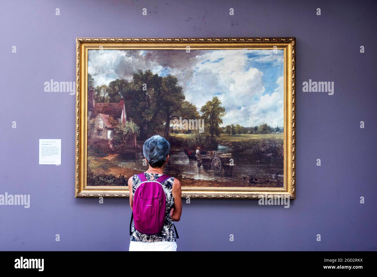 London, UK. 10th Aug, 2021. A woman views The Hay Wain by John Constable at  an outdoor pop-up gallery showcasing over 20 full sized reproductions of  popular National Gallery masterpieces along with
