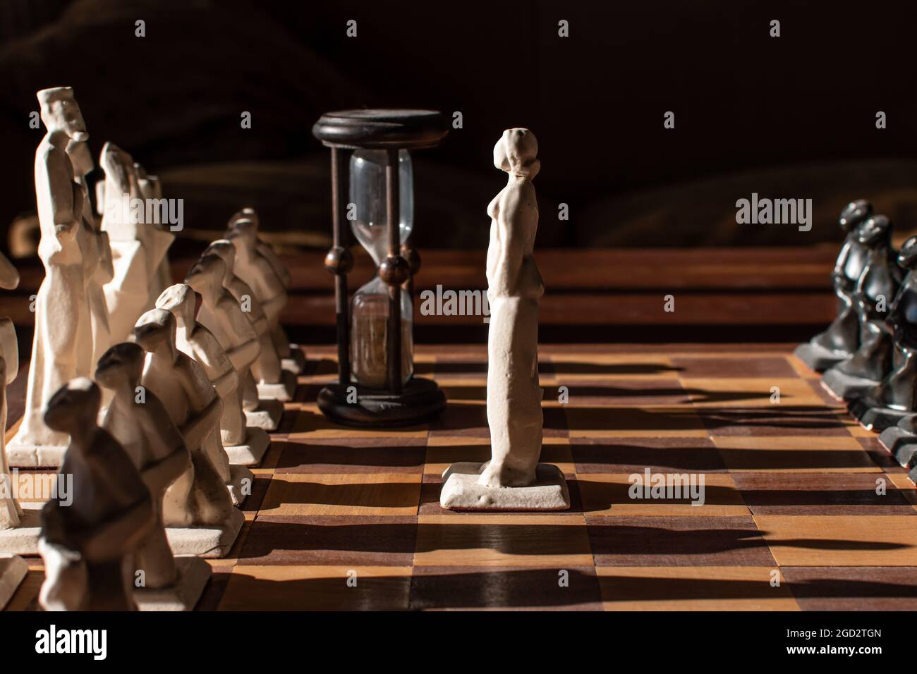 Queen confronting king and its army in chess board scene. Stock Photo