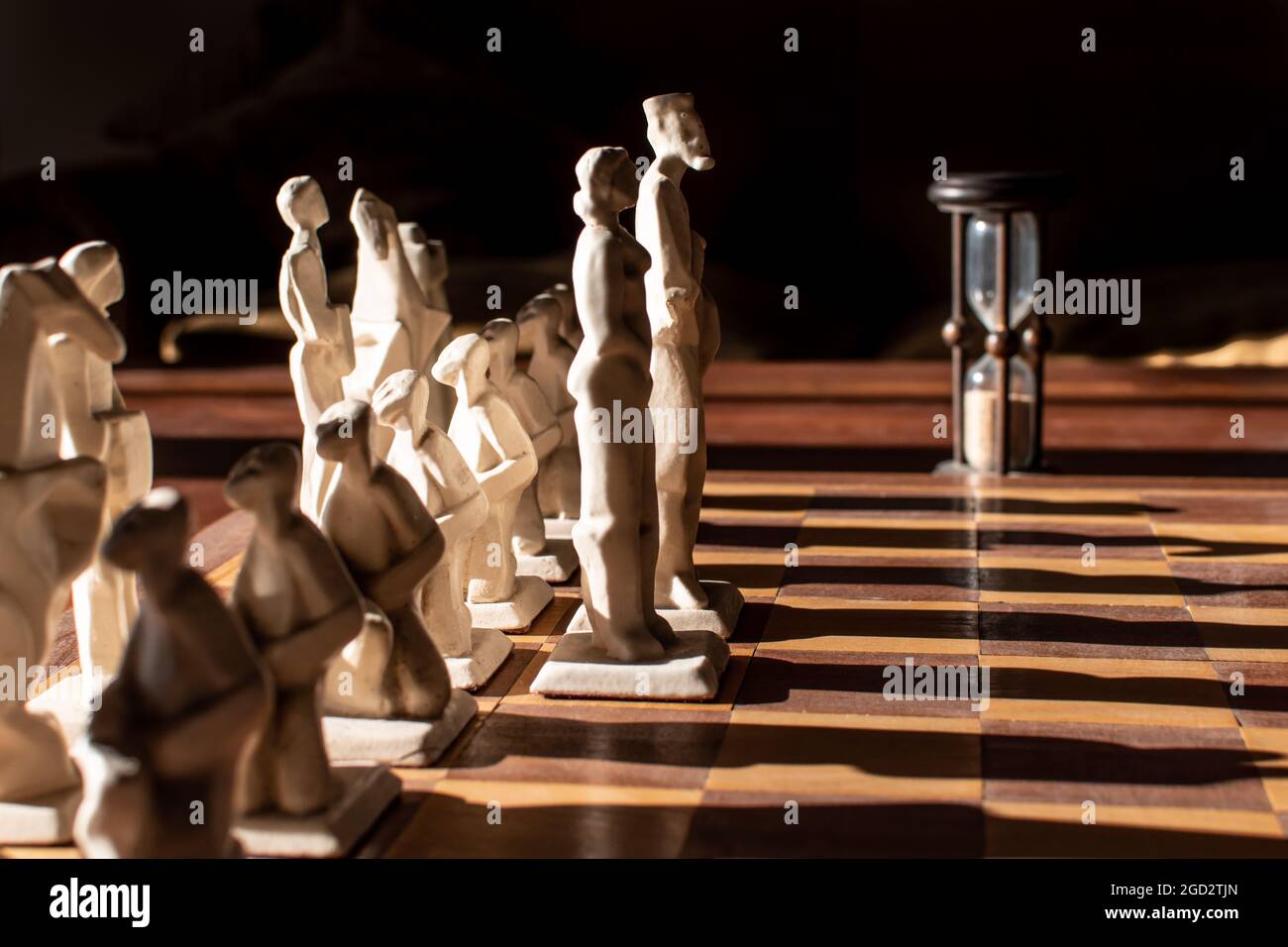 Chess figures arranged in scene showing the king and the queen leading their army Stock Photo