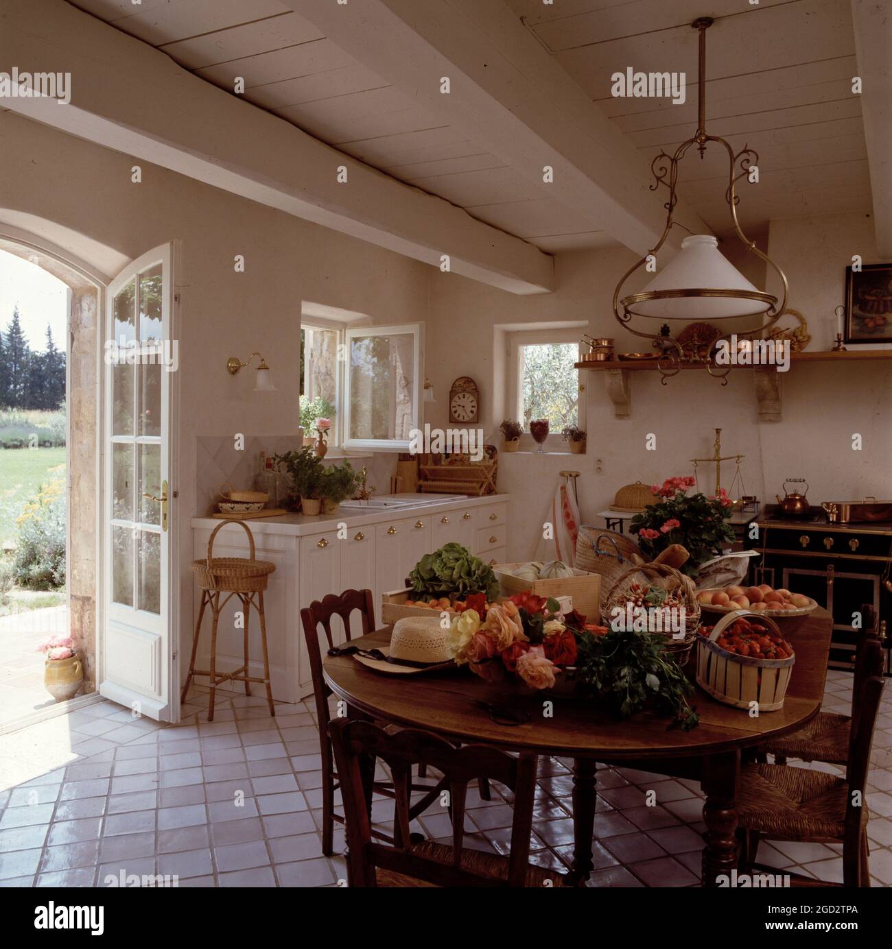 Large country kitchen with doors leading to garden. Stock Photo