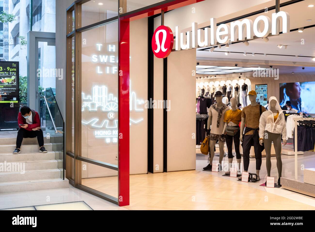 Hong Kong, China. 10th Aug, 2021. A man waits outside the Canadian sportswear clothing band, Lululemon store in Hong Kong. Credit: SOPA Images Limited/Alamy Live News Stock Photo