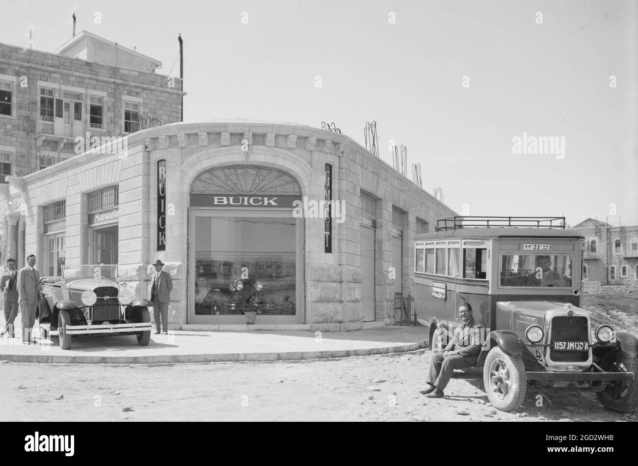 New Buick automobile and GMC bus outside the Buick agency (Buick Dealership) in Israel ca. between 1920 and 1935 Stock Photo