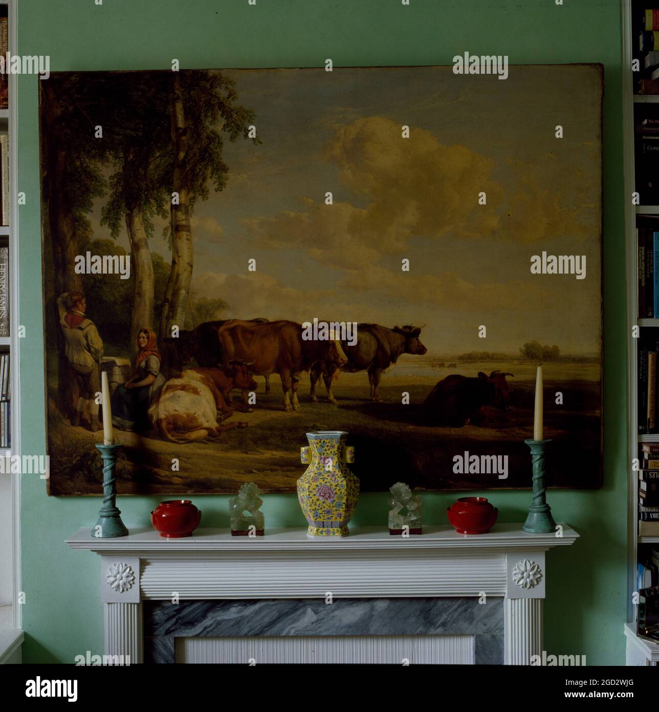 Large old painting of pastural scene over mantlepiece. Stock Photo