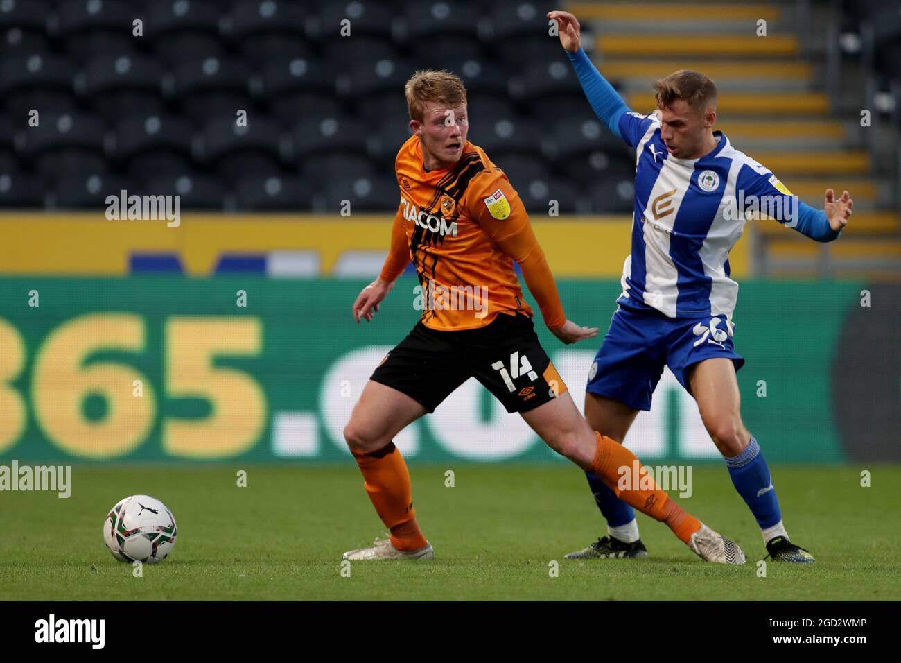Hull City's Andy Cannon (left) and Wigan Athletic's Scott Smith during the Carabao Cup first round match at the MKM Stadium, Hull. Picture date: Tuesday August 10, 2021. Stock Photo