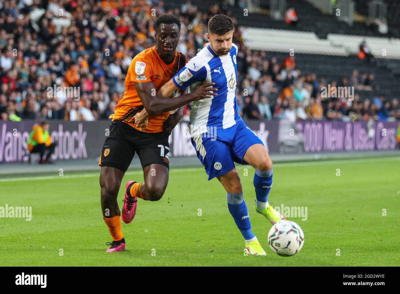 Josh Emmanuel #12 of Hull City challenges Jordan Jones #14 of Wigan ...