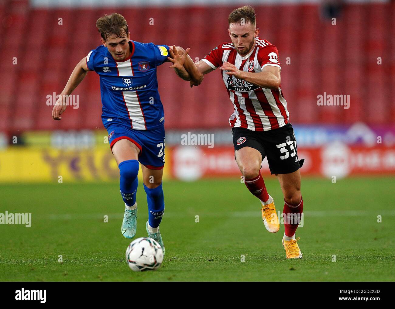 Sheffield, England, 10th August 2021.  Rhys Norrington Davies of Sheffield Utd challenges Lewis Bell of Carlisle United during the Carabao Cup match at Bramall Lane, Sheffield. Picture credit should read: Darren Staples / Sportimage Stock Photo