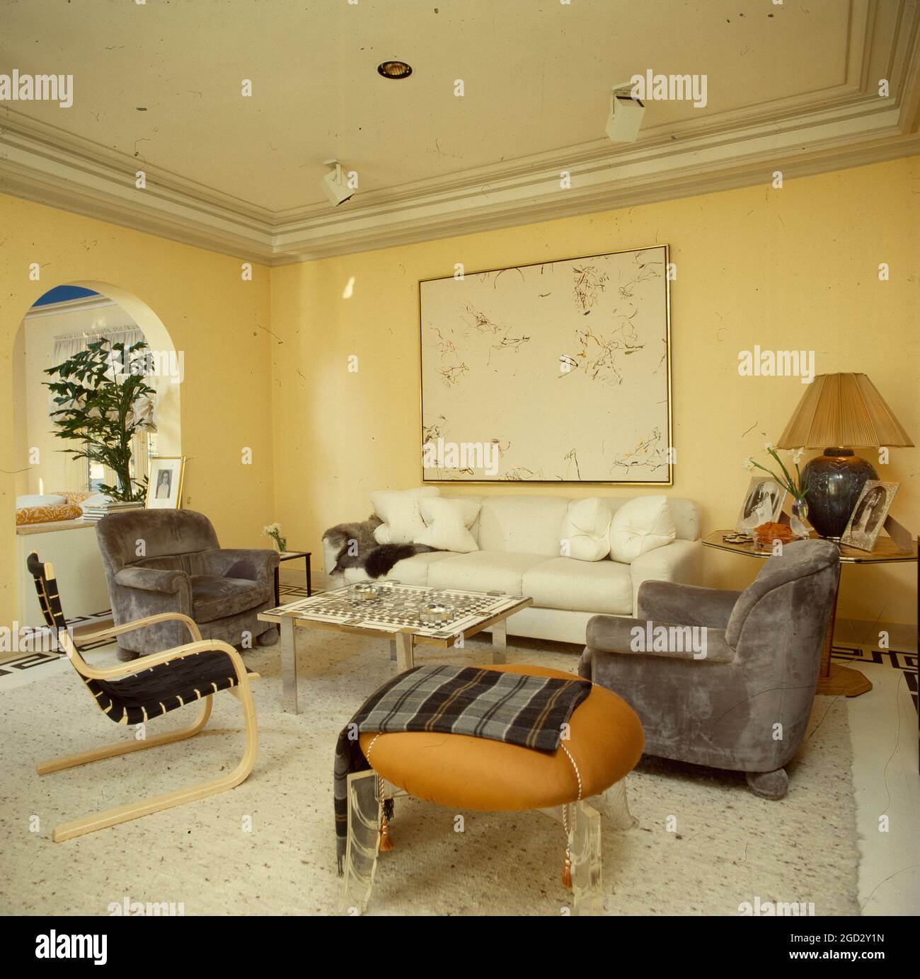 Designer livingroom in NYC with cream colour scheme and large painting. Stock Photo