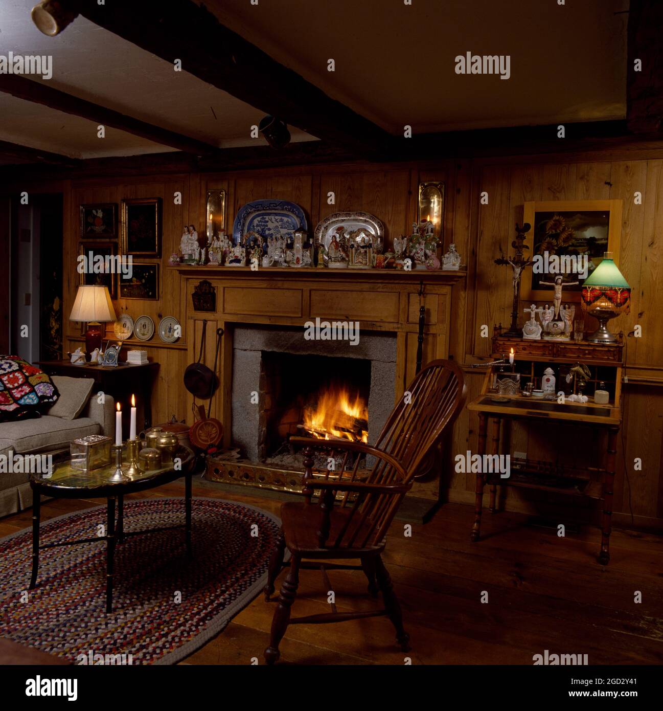 Closeup of open fire in wood panelled livingroom. Stock Photo