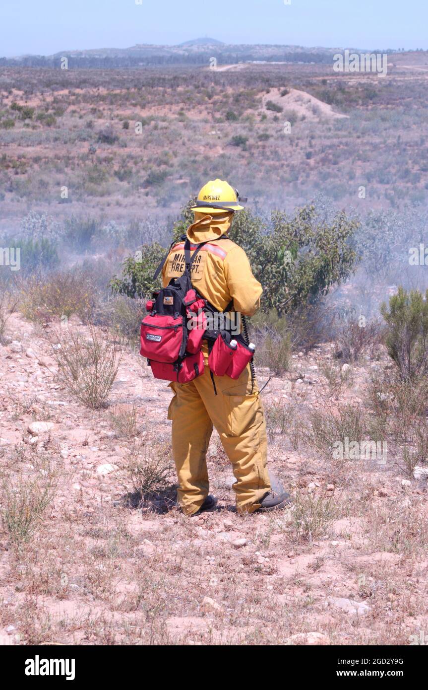 Miramar Firefighter observing fireground during controlled burn Stock Photo
