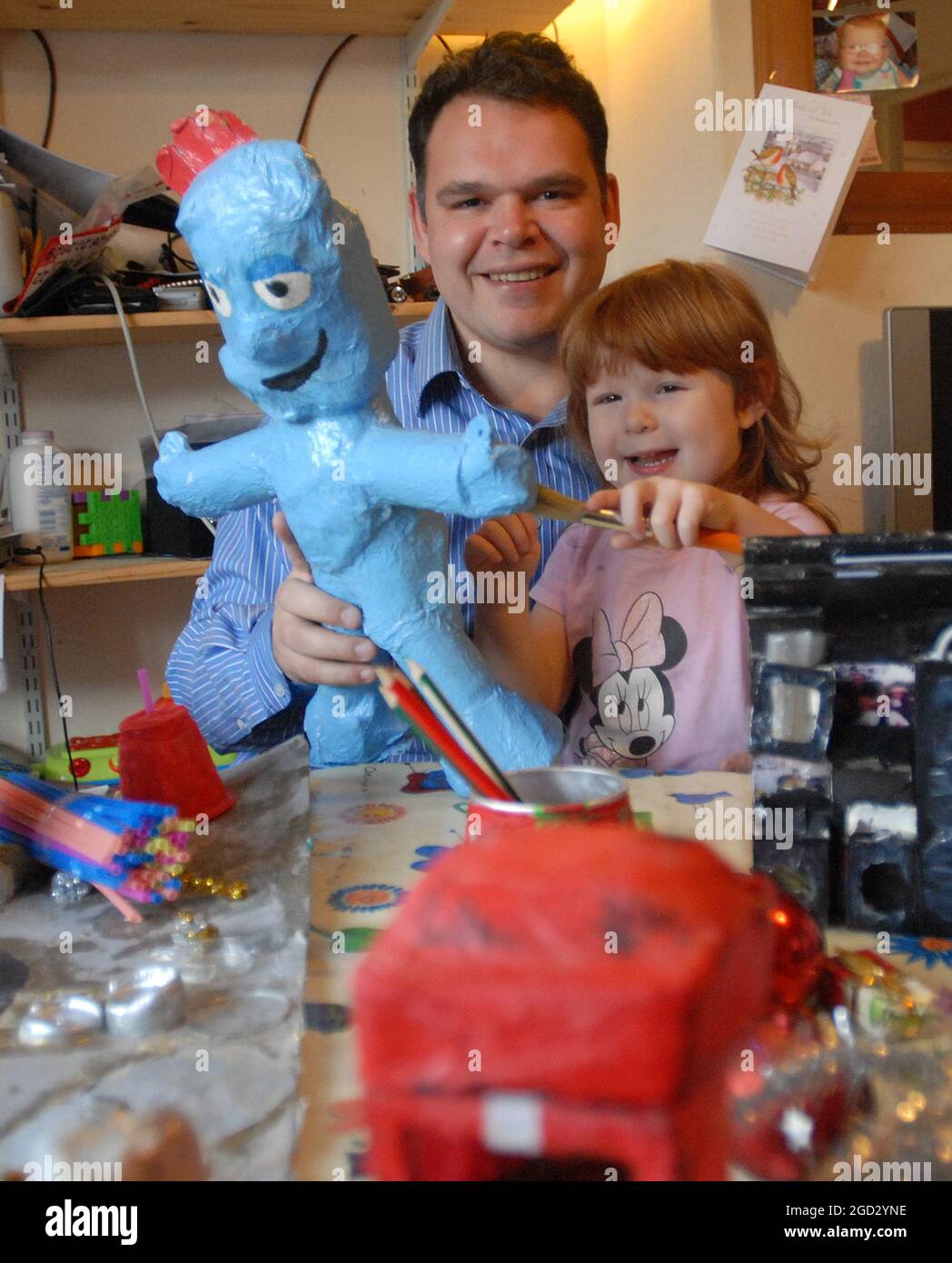 Matthew Taylor from Brighton  sets about making this years Christmas presents and decorations with daughter 3 year old Elizabeth with last years present Iggle Piggle made from toilet rolls. Pic Mike Walker, 2008 Stock Photo