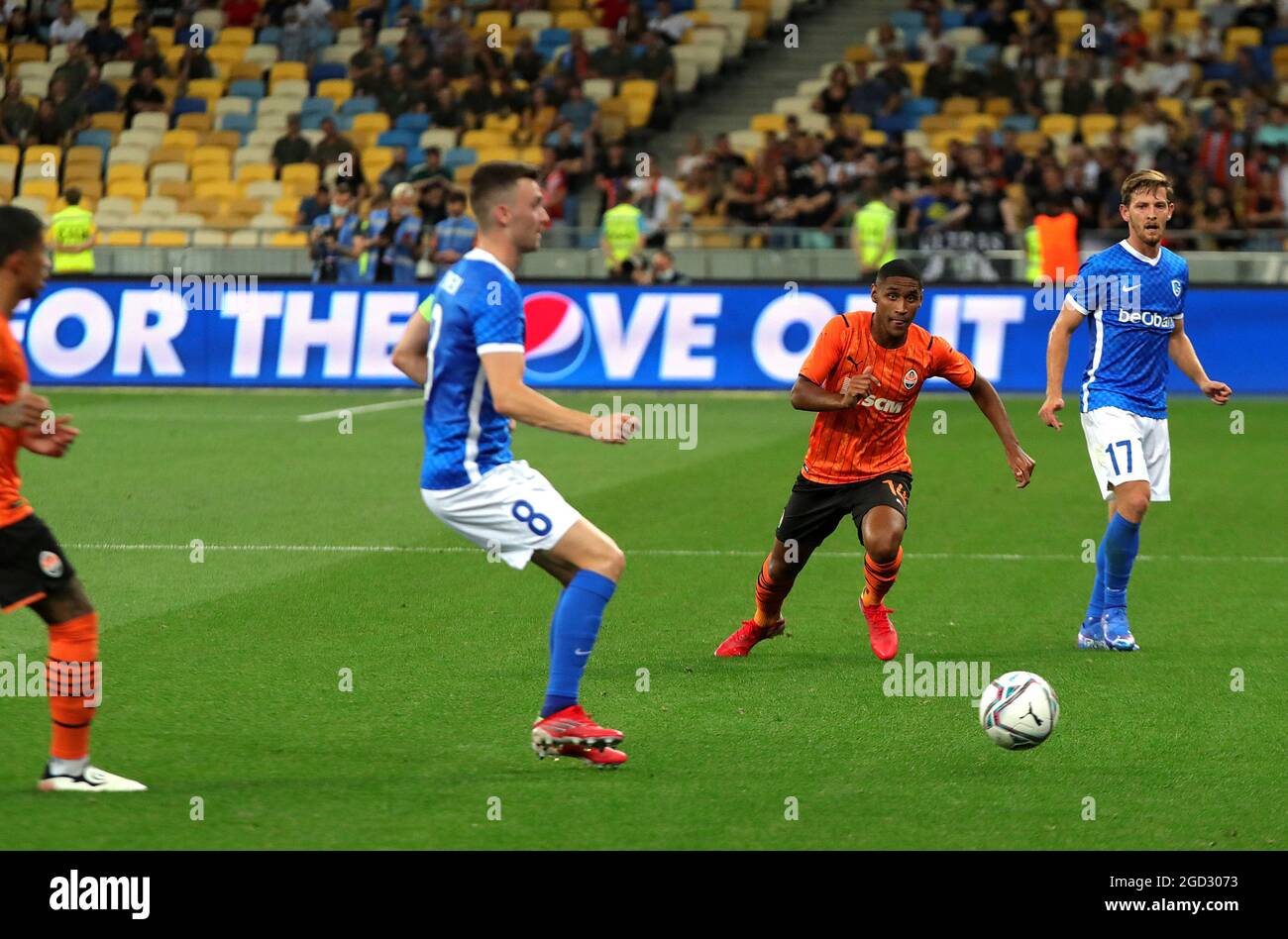 KYIV, UKRAINE - AUGUST 10, 2021 - Midfielder Tete (C) of FC Shakhtar Donetsk is seen in action with midfielders Bryan Heynen (L) and Patrik Hrosovsky (R) of KRC Genk during the 2021-22 UEFA Champions League third qualifying round second leg game at the NSC Olimpiyskiy, Kyiv, capital of Ukraine. Stock Photo