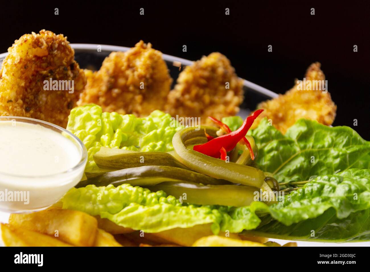 Chicken tenderloin with fries and lettuce Stock Photo Alamy