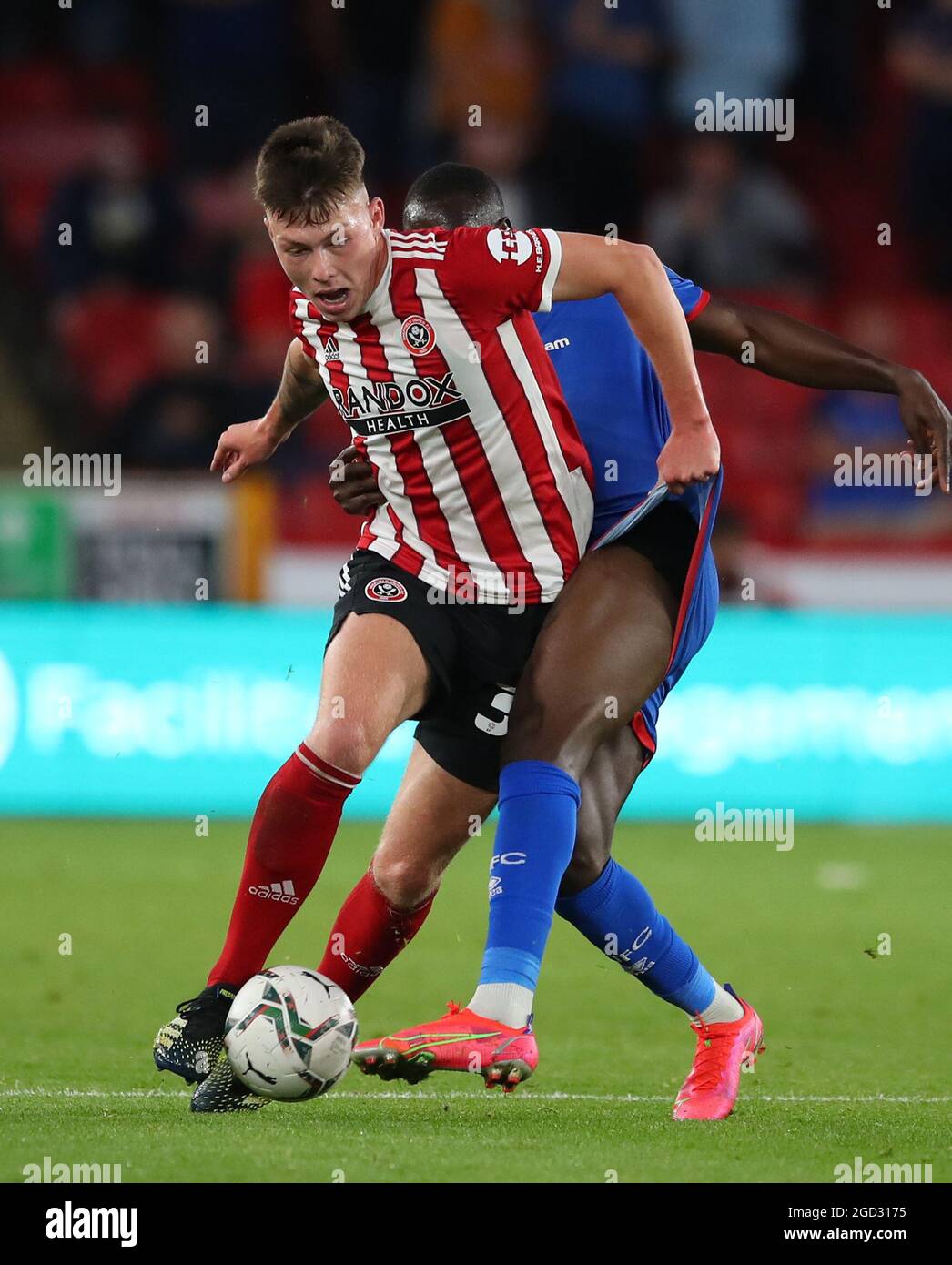 Sheffield, England, 10th August 2021. Kacper Lopata of Sheffield Utd tussles with Gime Toure of Carlisle Utd  during the Carabao Cup match at Bramall Lane, Sheffield. Picture credit should read: Simon Bellis / Sportimage Stock Photo
