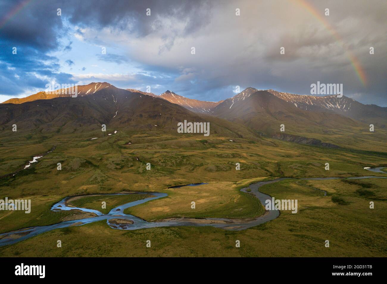 A midnight rainbow along the John River above the arctic circle in northern Alaska looking into the Gates of the Arctic National Park from just north Stock Photo