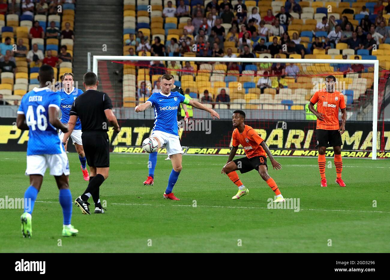 KYIV, UKRAINE - AUGUST 10, 2021 - Players of FC Shakhtar Donetsk (orange kit) and KRC Genk (blue kit) are seen during the 2021-22 UEFA Champions League third qualifying round second leg game at the NSC Olimpiyskiy, Kyiv, capital of Ukraine. Stock Photo