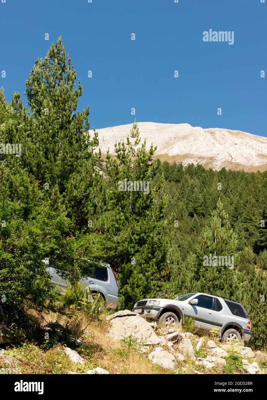 Parked cars by hiking trails area in the foot of Vihren Peak in Pirin National Park and Reserve, Pirin Mountain, Bulgaria, Balkans, Europe Stock Photo