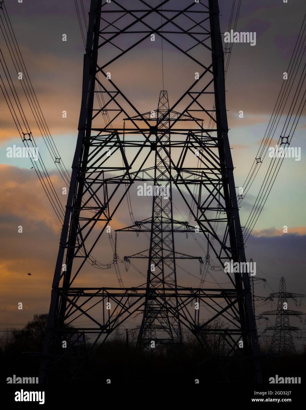 High voltage towers and power site under the scenic sunset Stock Photo ...