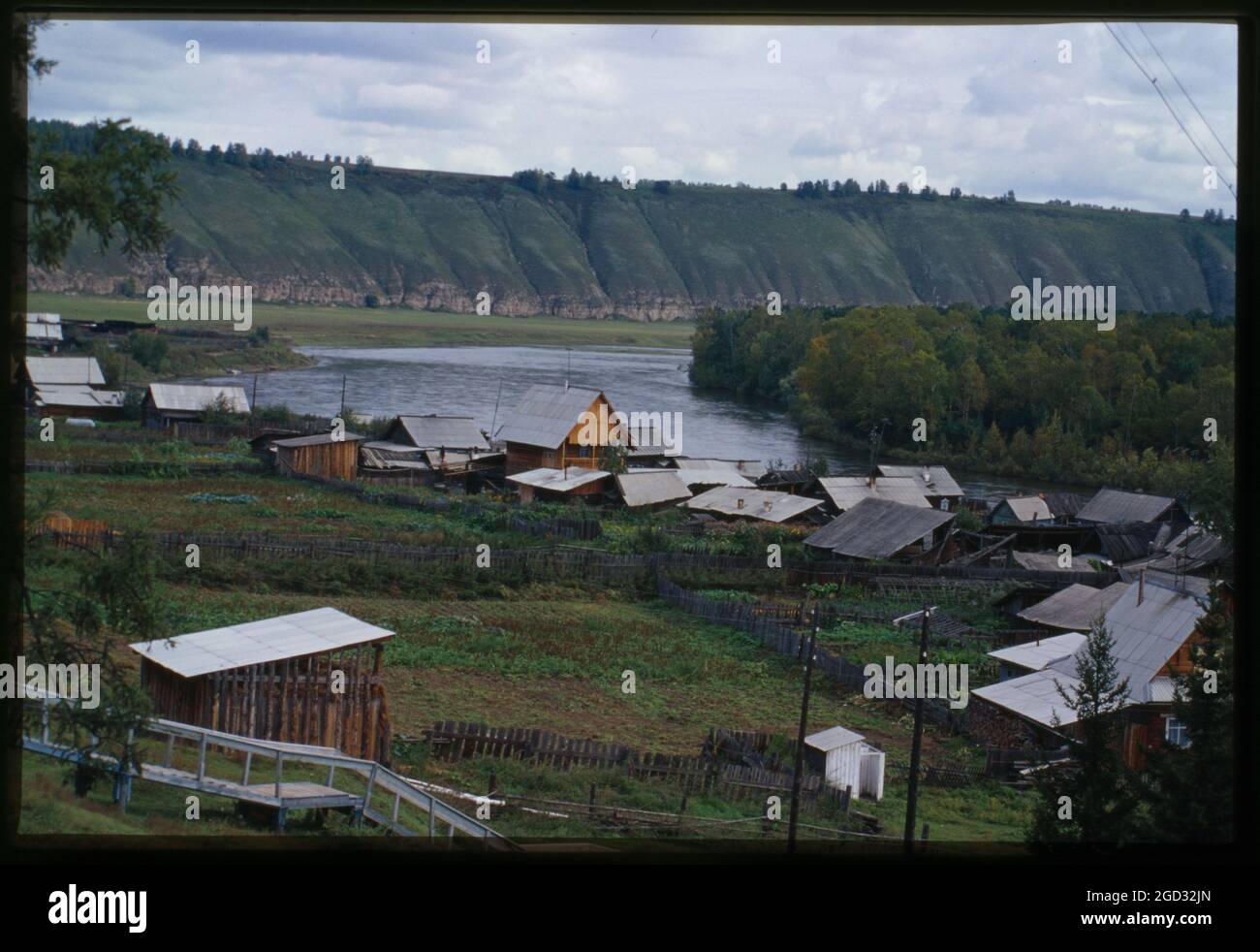Log houses, with Belaia River in background, Bel'sk, Russia; 2000 Stock Photo