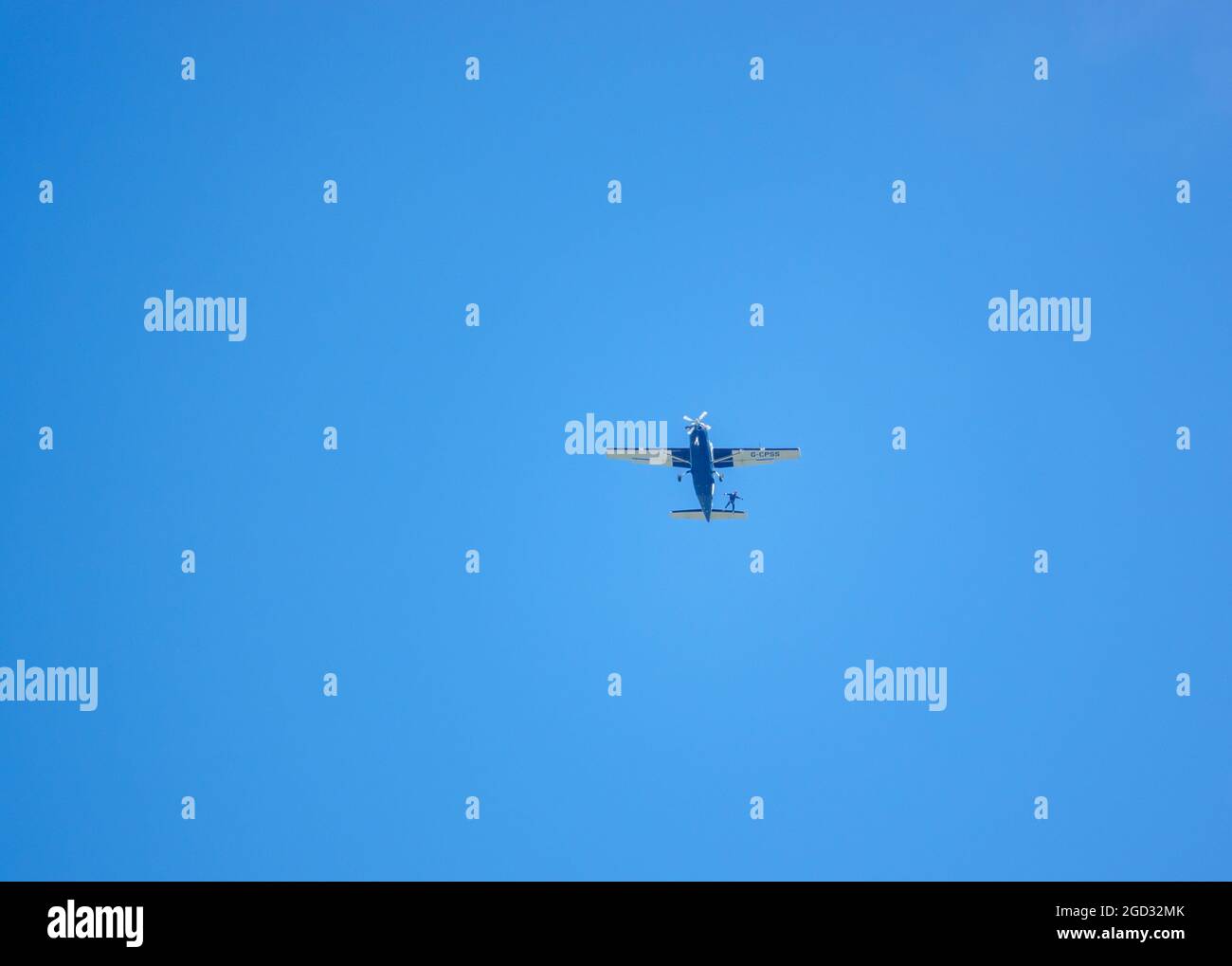 Eressing looking up at a parachute jumper egressing a light aircraft flying ...
