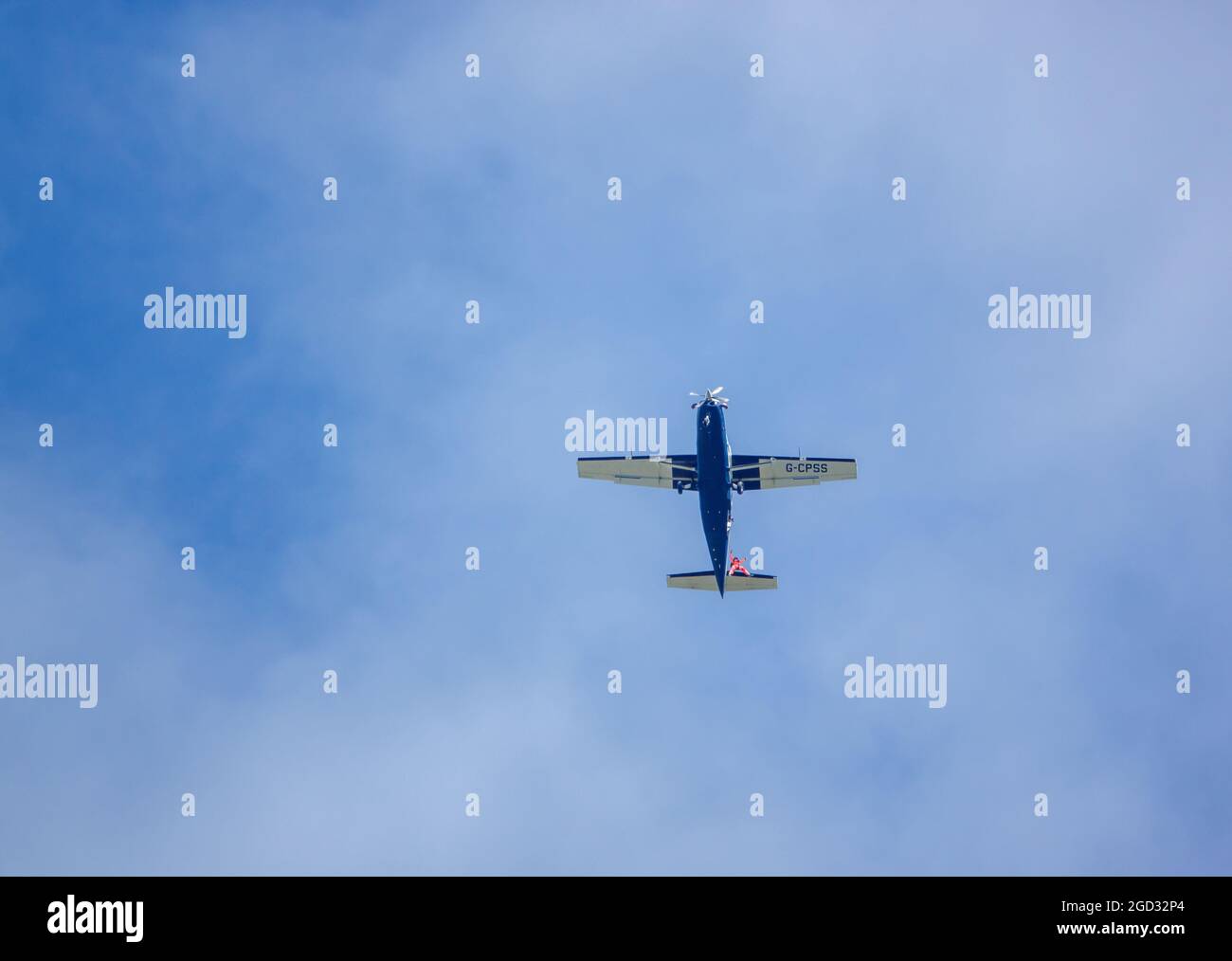 Eressing looking up at a parachute jumper egressing a light aircraft flying ...