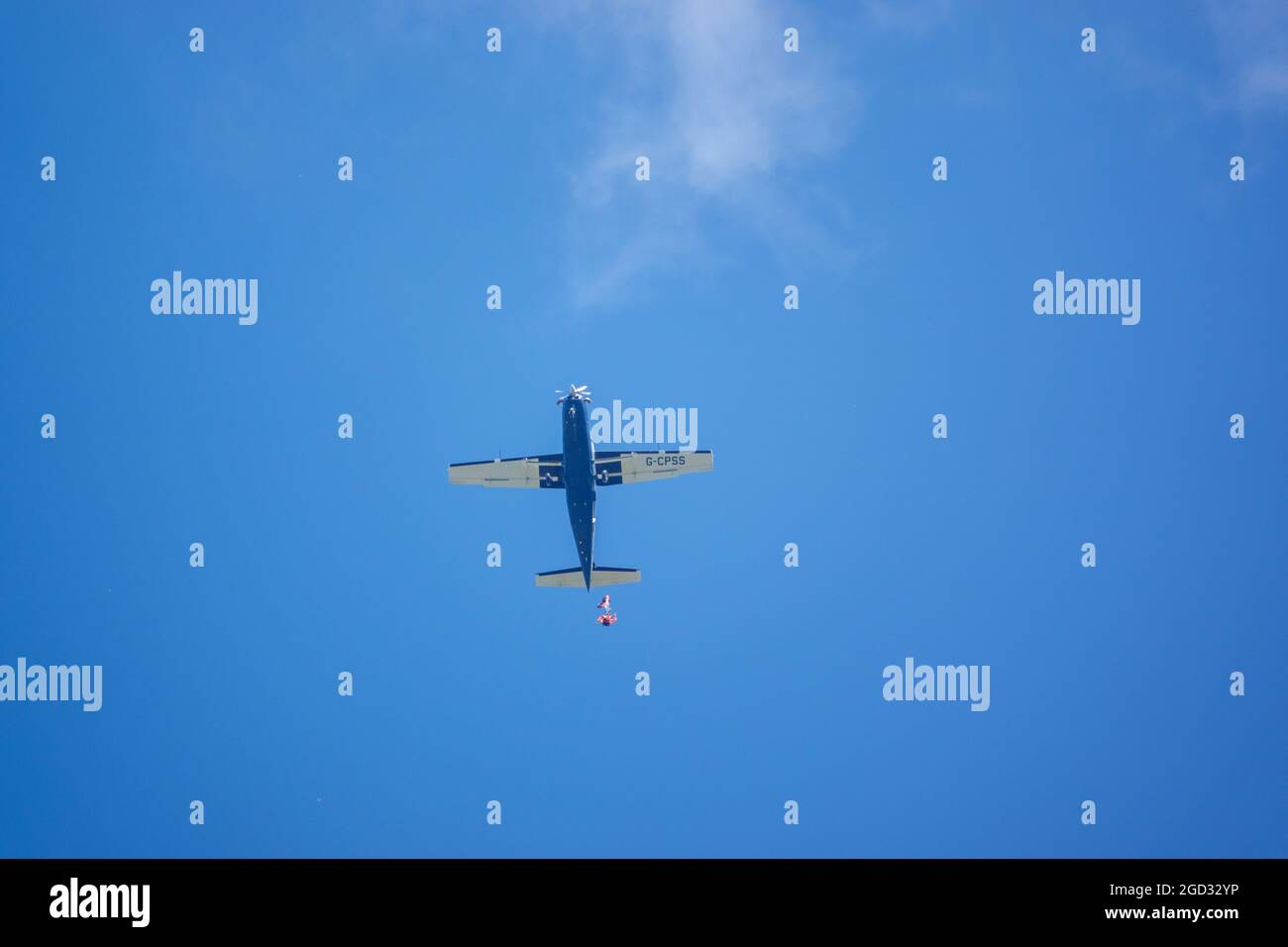 Eressing looking up at a parachute jumper egressing a light aircraft flying ...