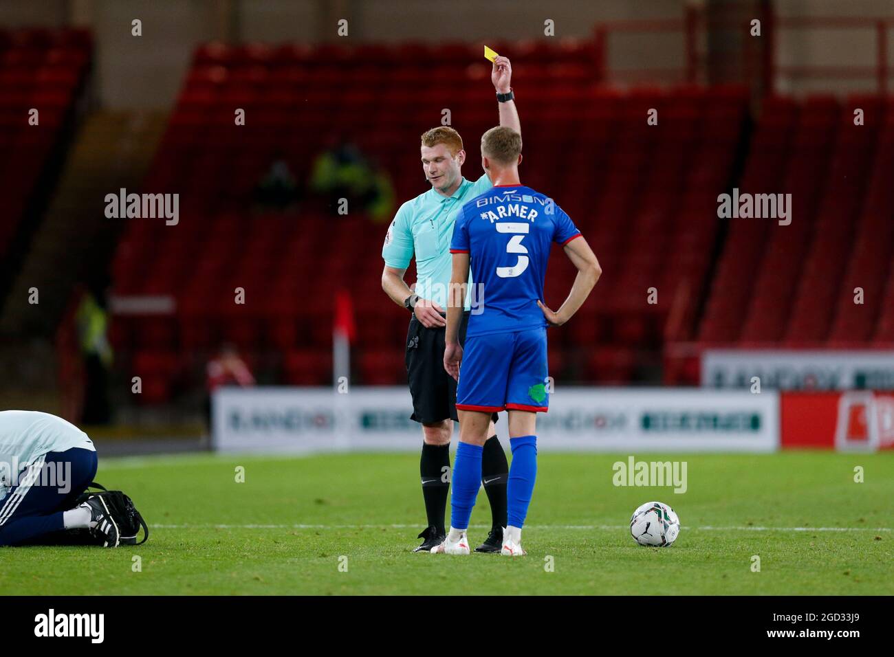 The referee issues a yellow card to Jack Armer #3 of Carlisle United Stock Photo