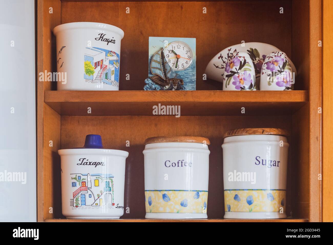 Traditional ceramic set storage for sugar, coffee and spices. Cookware details on kitchen shelf in Greek house, in Greece Stock Photo