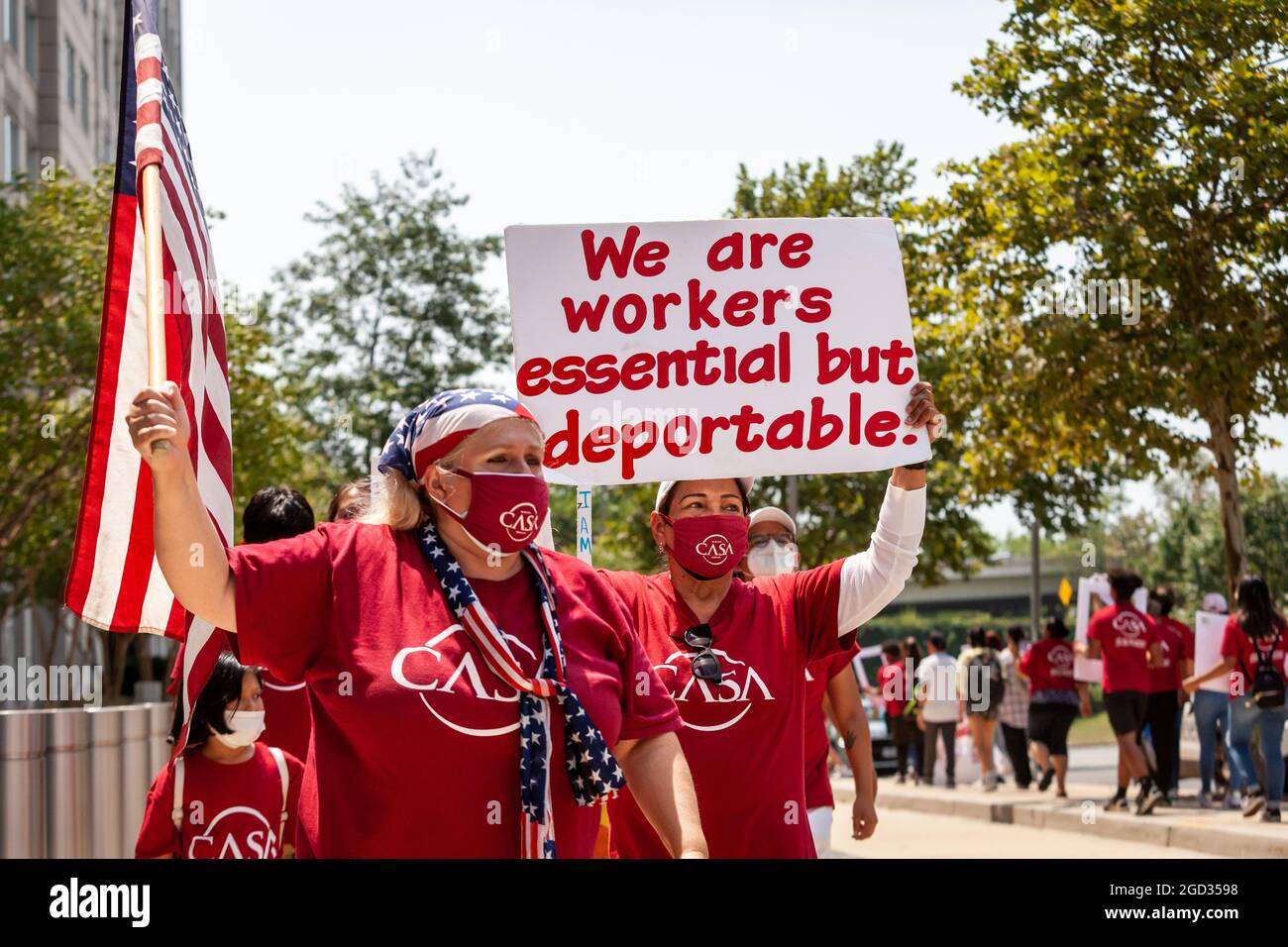 Washington, DC, USA, 10 August, 2021.  Pictured: Immigrants and supporters march in front of the Immigration and Customs Enforcement (ICE) building during a rally demanding that ICE treat immigrants as people, not simply 'priority' or 'non-priority' categories.  Credit: Allison Bailey / Alamy Live News Stock Photo