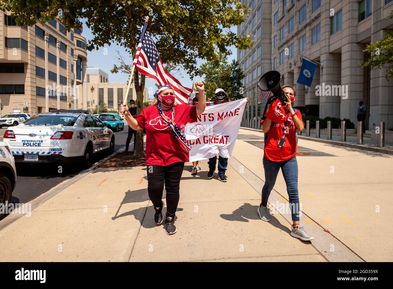 Washington, DC, USA, 10 August, 2021.  Pictured: Immigrants and supporters march in front of the Immigration and Customs Enforcement (ICE) building during a rally demanding that ICE treat immigrants as people, not simply 'priority' or 'non-priority' categories.  Credit: Allison Bailey / Alamy Live News Stock Photo