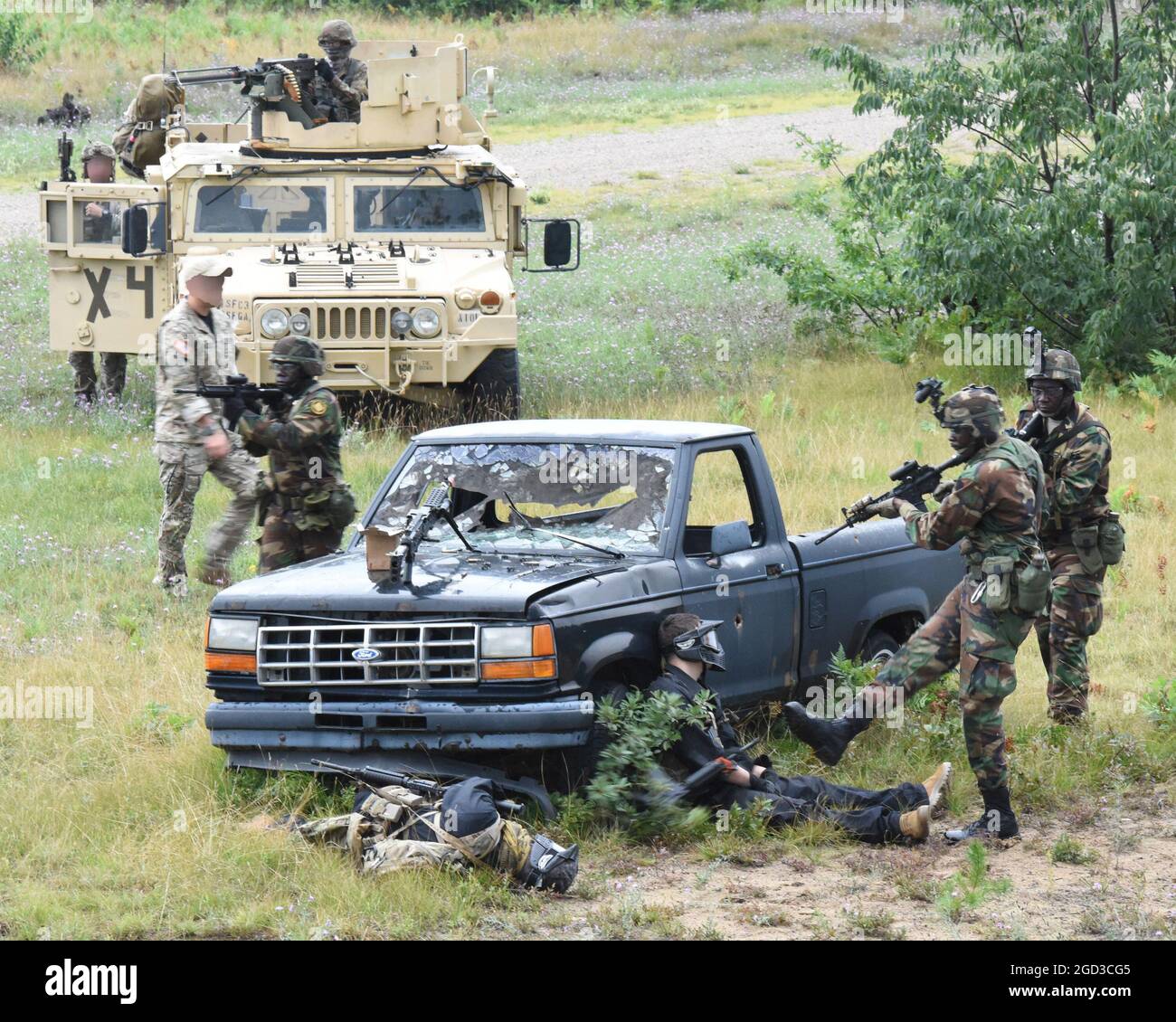 A soldier with the Armed Forces of the Republic of Liberia kicks away a weapon while conducting tactical training with members of the U.S. Army during Northern Strike 21 (NS21), Camp Grayling Joint Maneuver Training Center, Grayling, Michigan, Aug. 9, 2021. Soldiers from Liberia, part of Michigan National Guard’s State Partnership Program, are at Camp Grayling participating in Michigan National Guard’s Northern Strike 21 Exercise and will make up part of an estimated 5,100 participants from various states and countries. (U.S. Air National Guard photo by Master Sgt. David Eichaker) (This photo Stock Photo