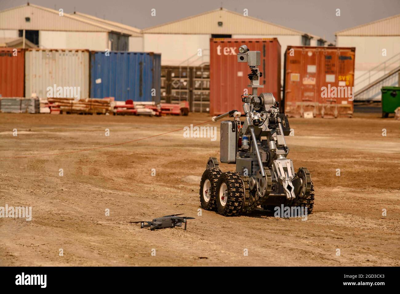 A Remotec ANDROS F6A robot is seen approaching a DJI Mavic Air 2 unmanned  aerial system during a training exercise at Al Dhafra Air Base, United Arab  Emirates, Aug. 6, 2021. The