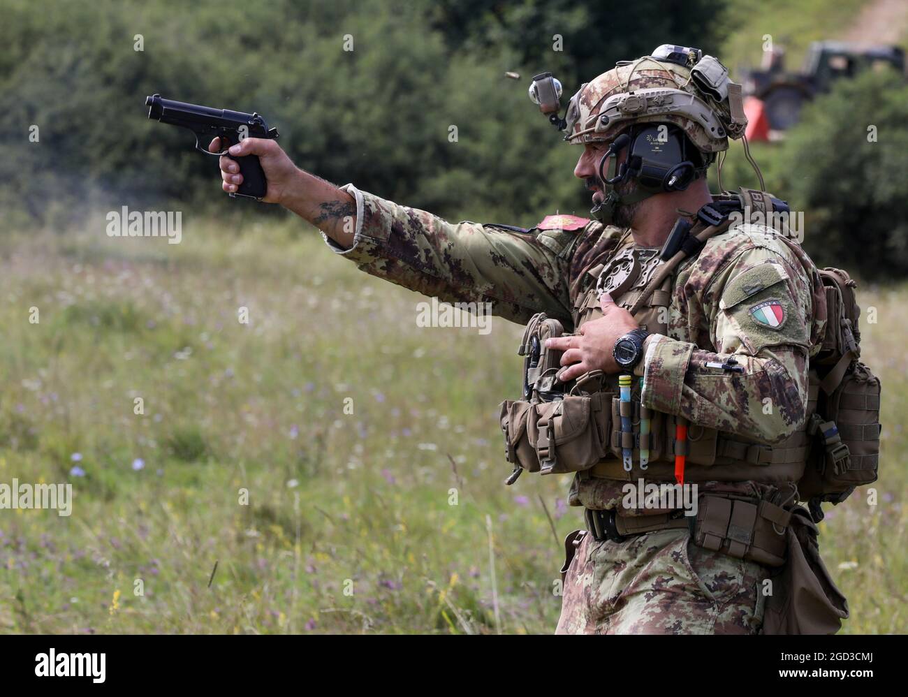 An Italian sniper competitor fires his pistol at paper targets during the Mogadishu event on Hohenfels Training Area Germany, Aug. 9, 2021. The 2021 European Best Sniper Team Competition is a U.S. Army Europe and Africa-directed, 7th Army Training Command hosted contest of skill that includes 14 participating NATO allies and partner nations at 7th ATC’s Hohenfels Training Area, Aug 8-14. (U.S. Army  photo by Spc. Zack Stahlberg) Stock Photo