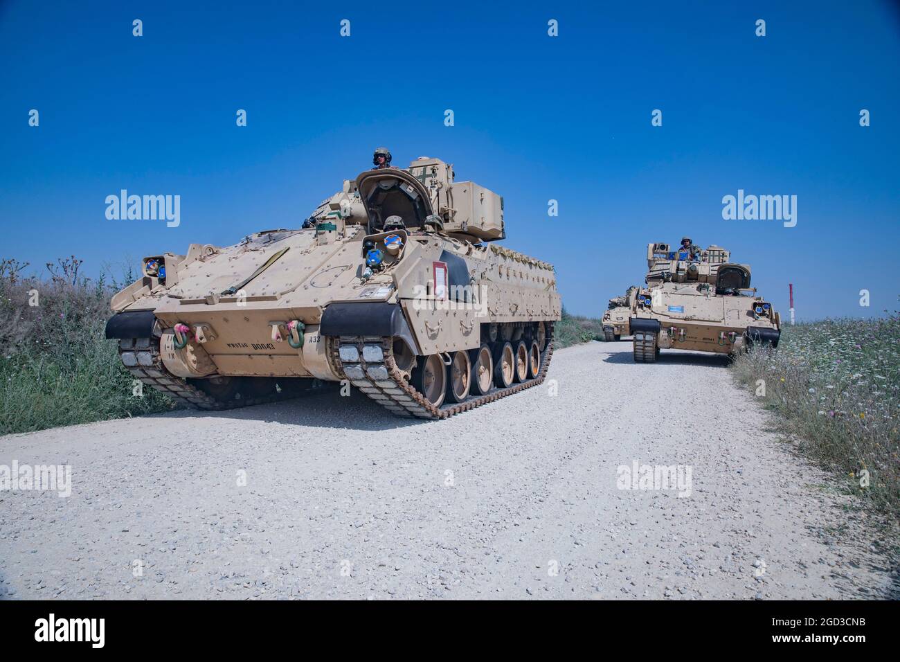 Soldiers assigned to 1st Battalion, 16th Infantry Regiment, 1st Heavy Brigade Combat Team, 1st Infantry Division conducted railhead operations to deliver a fleet of military vehicles to MK Air Base, Romania on July 28, 2021. The M2A3 Bradley Fighting Vehicle weighs over 55,200 pounds and travels at speeds of over 30 mph. It is instantly recognizable in the field by its massive 25mm M242 Bushmaster chain gun sitting on top of the vehicle. It can fire over 500 rounds per minute.   (U.S. Army photo by Spc. Jameson Harris / 22nd Mobile Public Affairs Detachment) Stock Photo