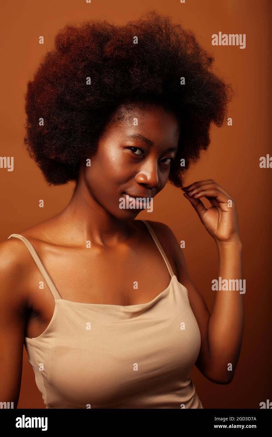 pretty young african american woman with curly hair posing cheerful ...