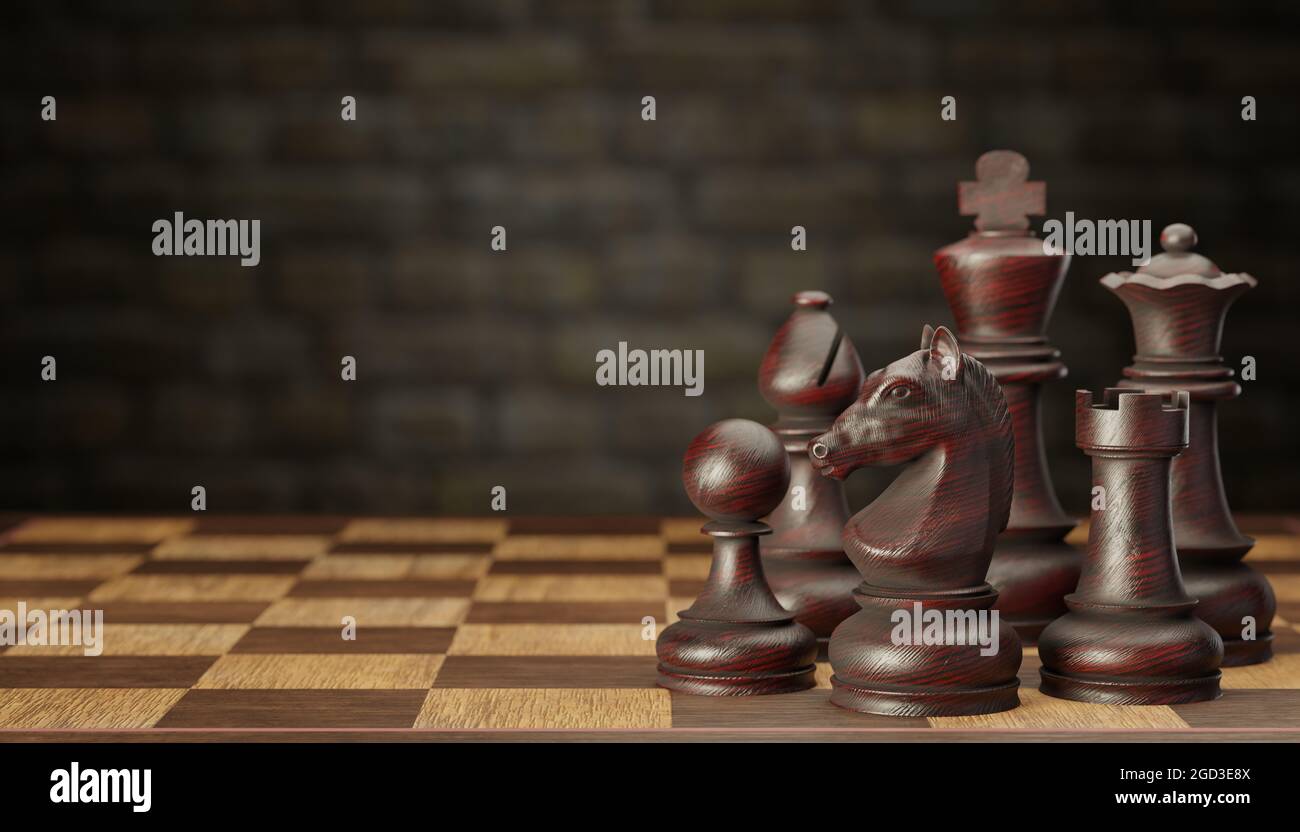 A set of dark wooden chess pieces placed on a chessboard in a brick wall background. The concept of business strategy planning. copy space for text or Stock Photo