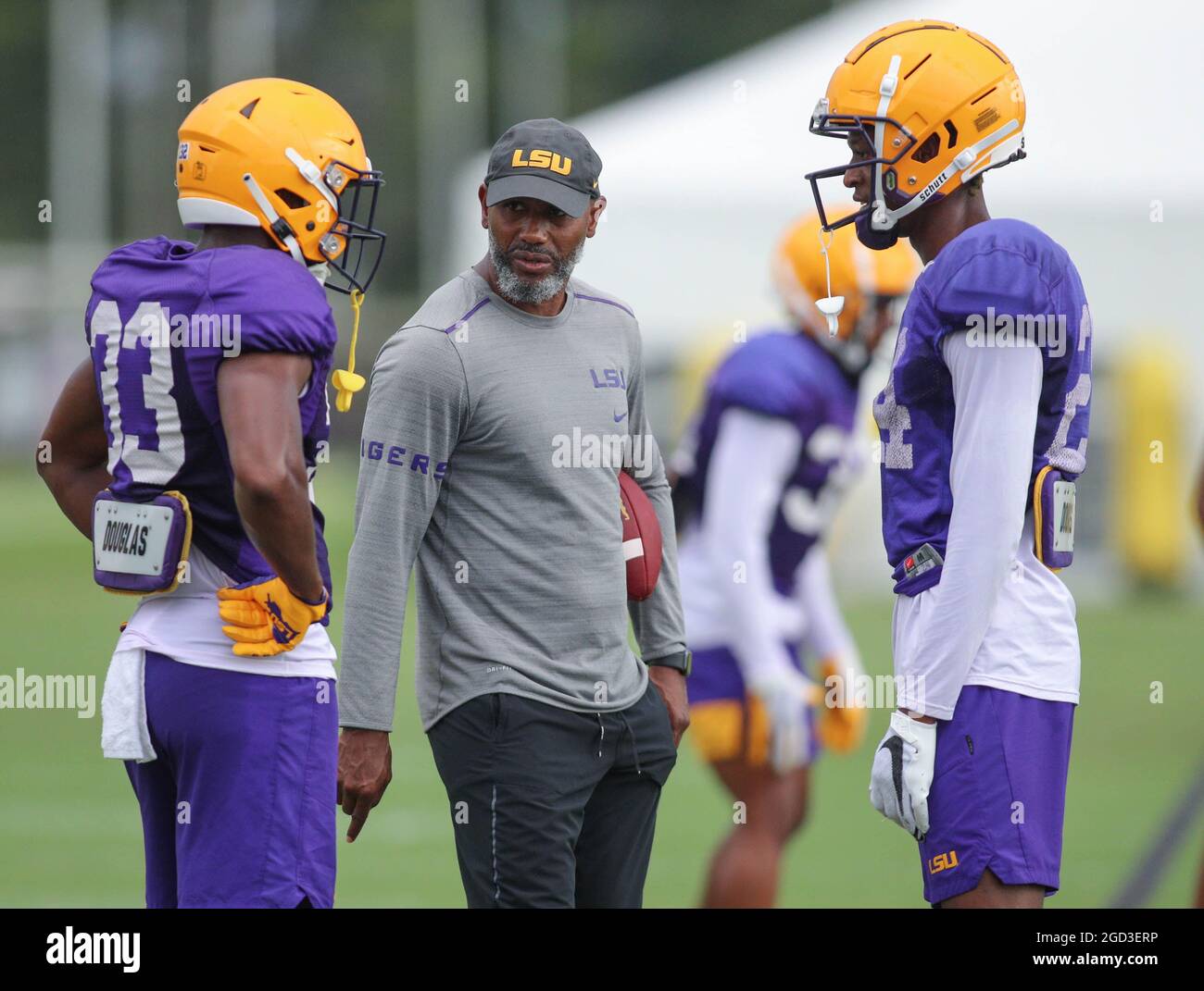 August 10, 2021: LSU Defensive Back Coach Corey Raymond talks with Lloyd Cole (33) and Darren Evans (24) during the first week of fall football camp at the LSU Charles McClendon Practice Facility in Baton Rouge, LA. Jonathan Mailhes/CSM Stock Photo