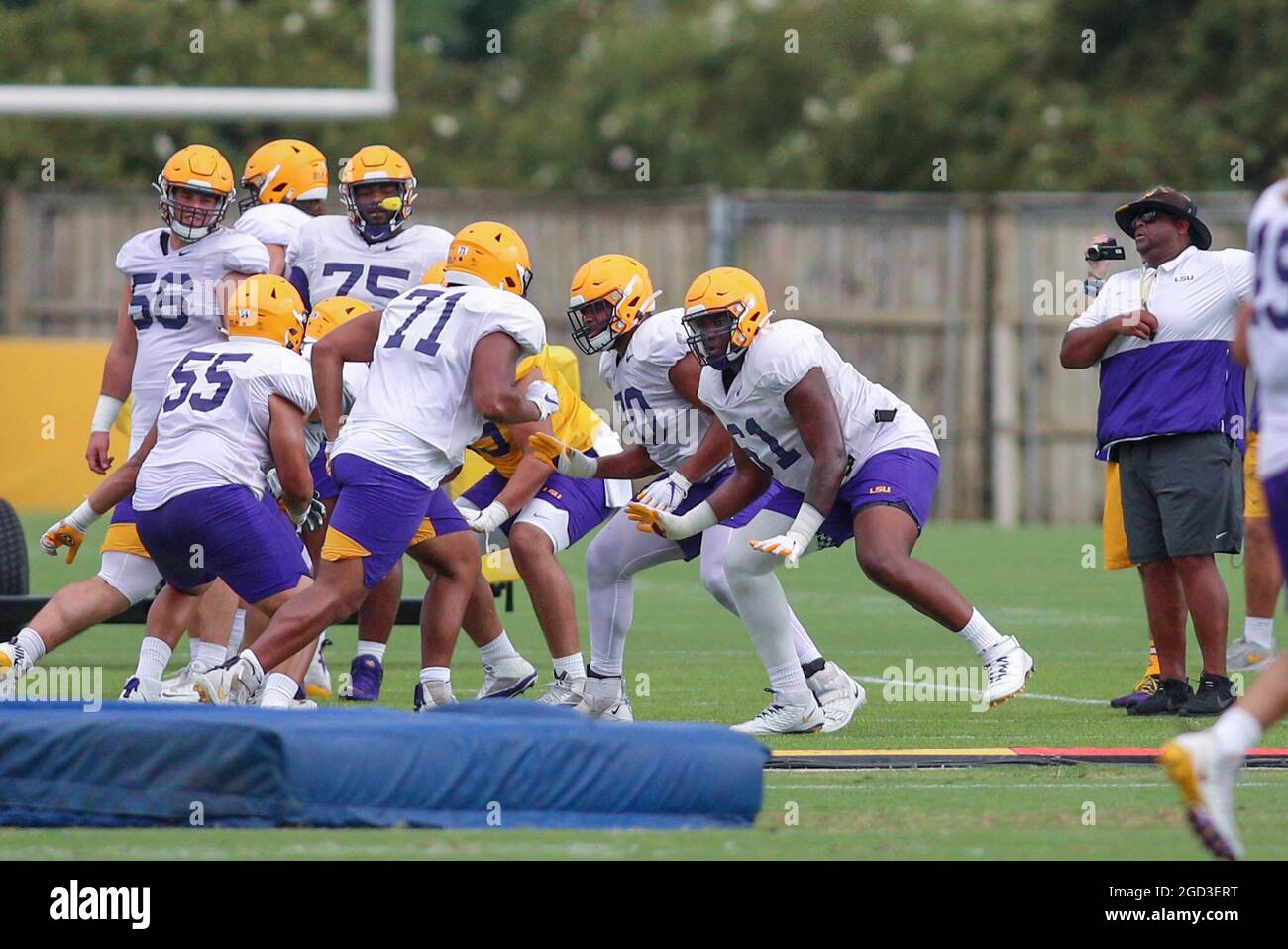 August 10, 2021: LSU Offensive Line Coach Brad Davis put lineman Cameron  Wire (61), Ed Ingram (70), Xavier Hill (71) and Kimo Makane'ole (55)  through a drill during the first week of
