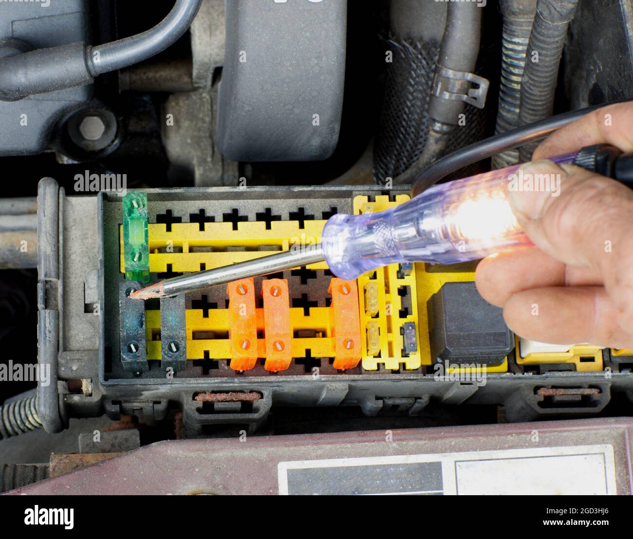 A High Angle View of an Automotive Technician Using a Test Light Stock Photo