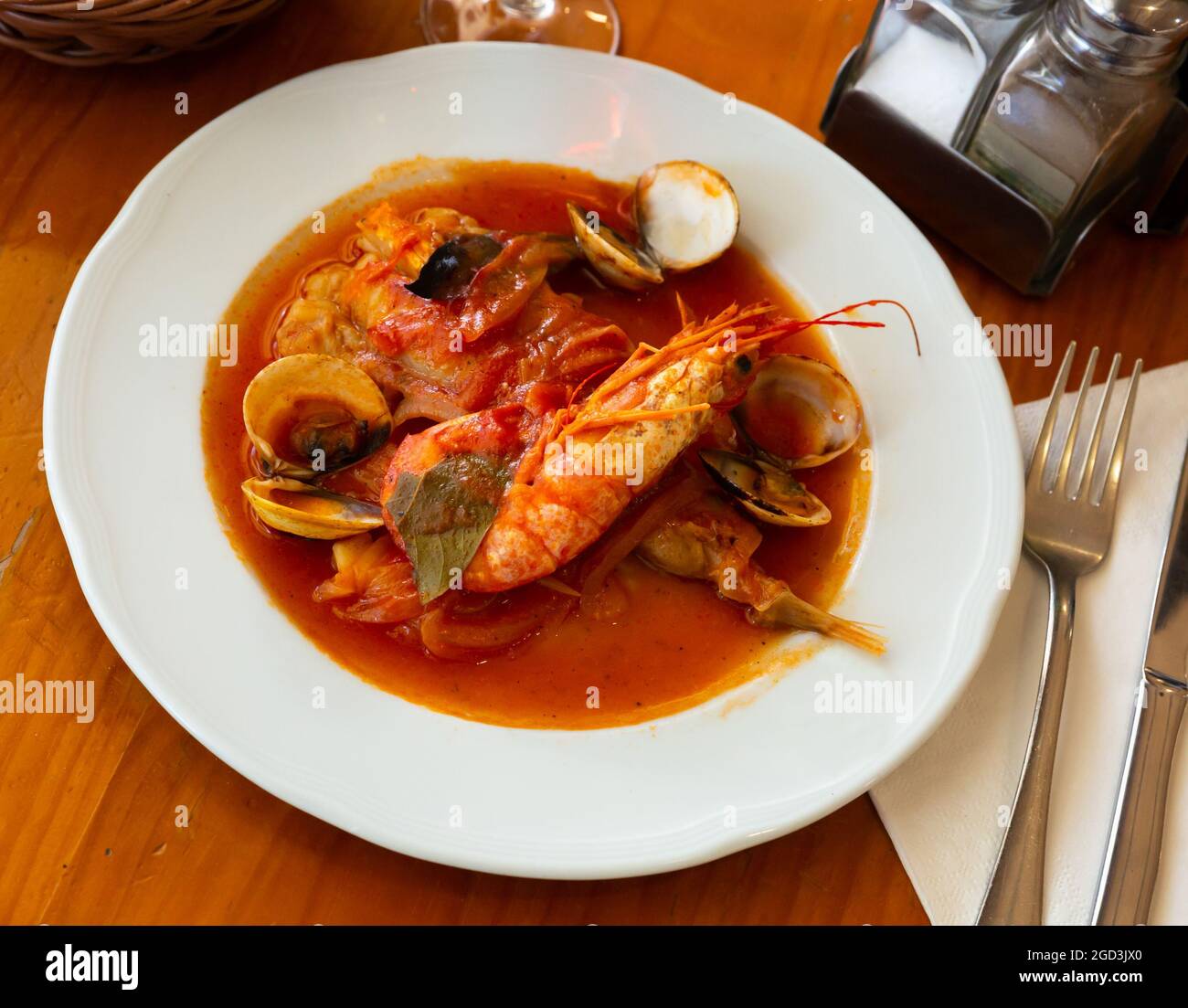 Tail of monkfish with shellfish, prawns Stock Photo