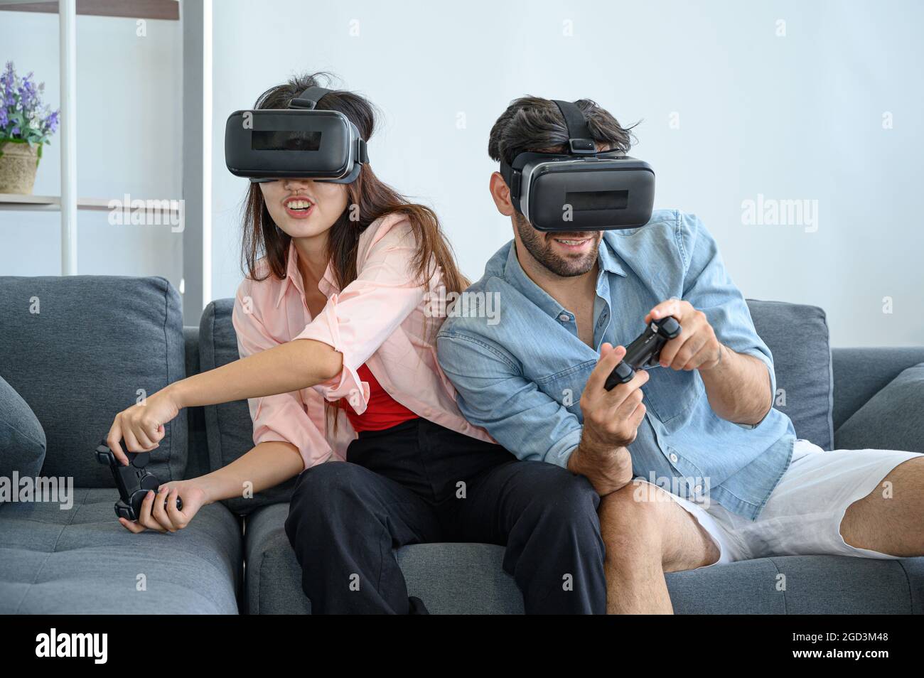Couple lovers enjoy  playing VR game together at home. Family relationship concept. Stock Photo
