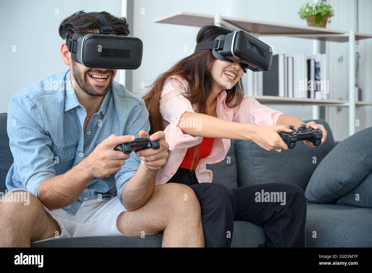 Couple lovers enjoy  playing VR game together at home. Family relationship concept. Stock Photo
