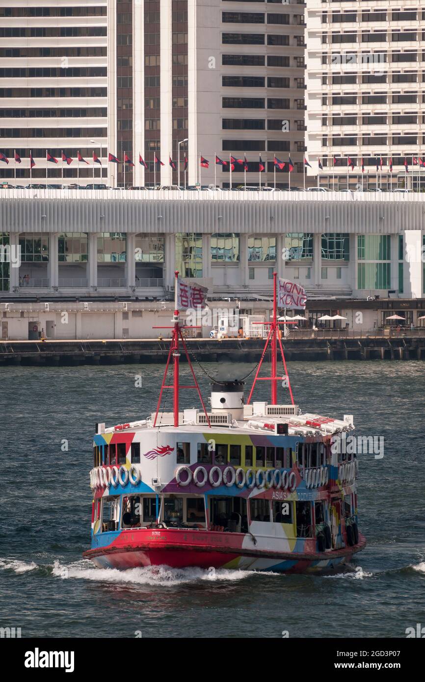 The 'Night Star', one of the Star Ferry fleet, crosses Victoria Harbour from Tsim Sha Tsui to Central Ferry Pier 7 on Hong Kong Island Stock Photo